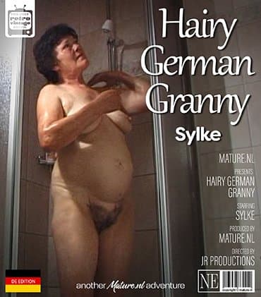 German granny Sylke plays with her hairy pussy in the shower